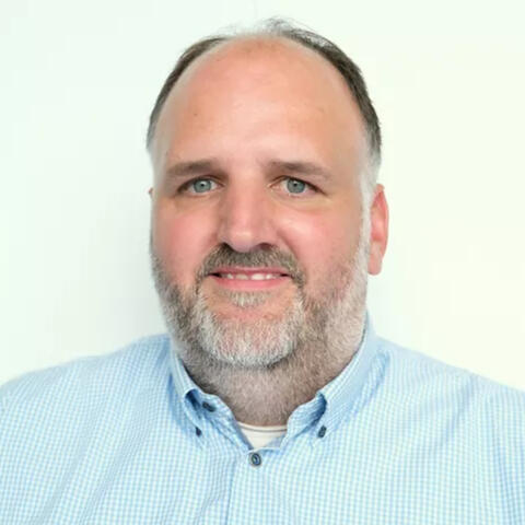 Headshot of a smiling man